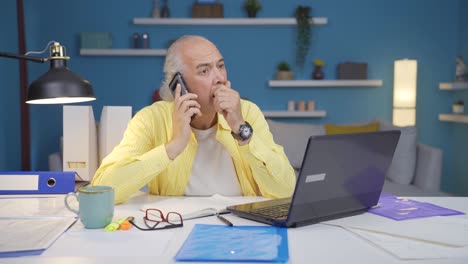 Home-office-worker-old-man-getting-bad-news-on-the-phone.
